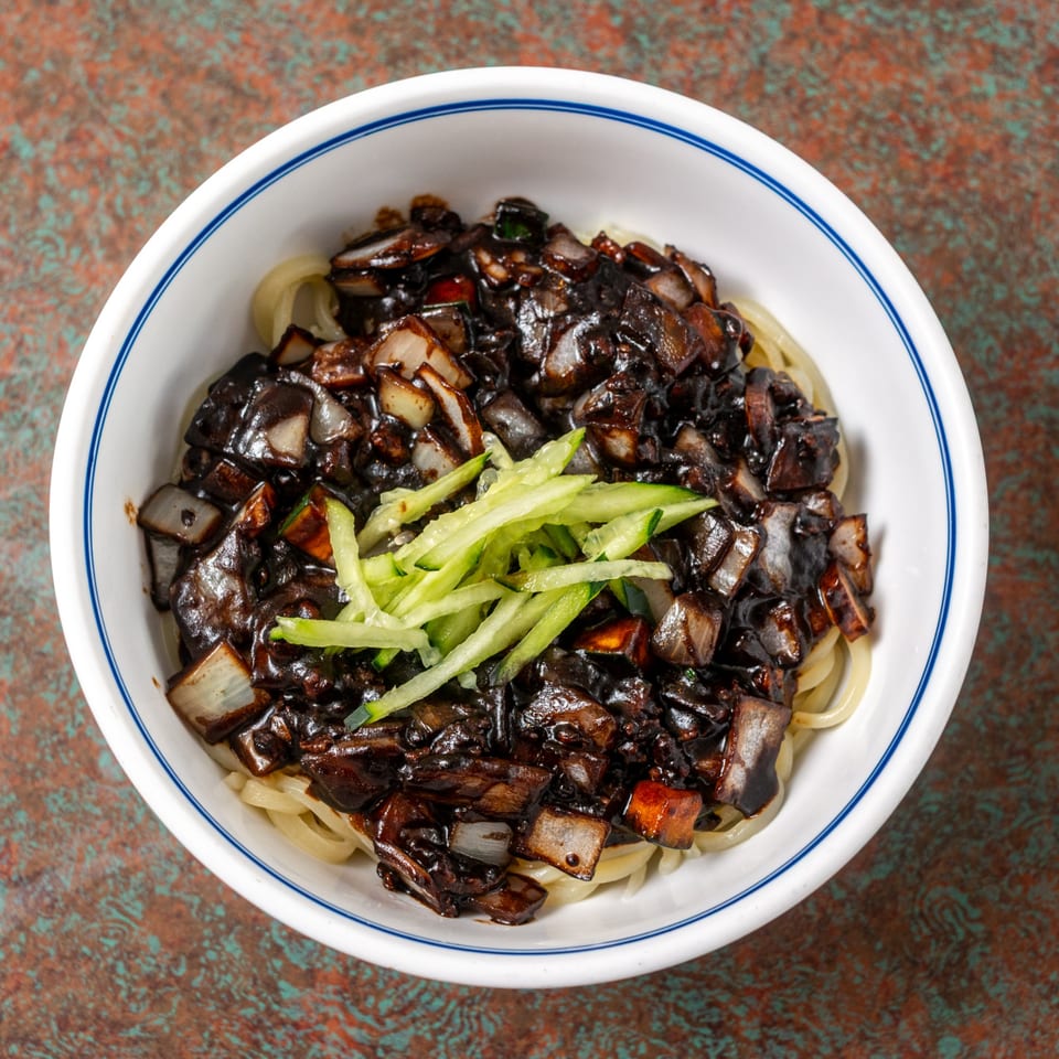 Ming's Restaurant's Jajangmyeon, a bowl of noodles topped with black bean sauce, pork, and vegetables.