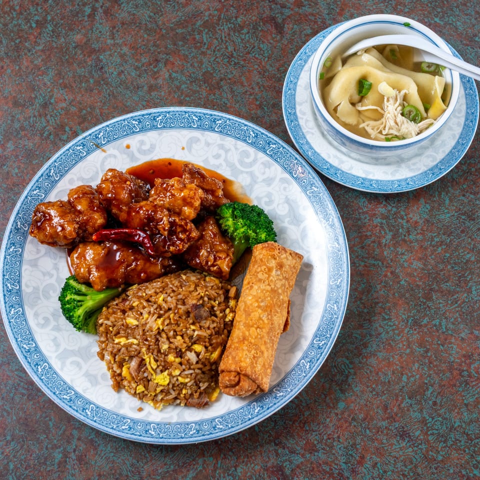 Orange chicken with broccoli, fried rice, an egg roll, and a side of wonton soup.